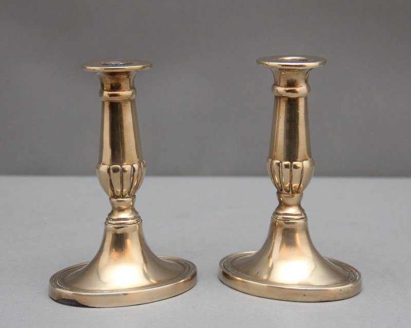 A pair of brass Georgian candlesticks