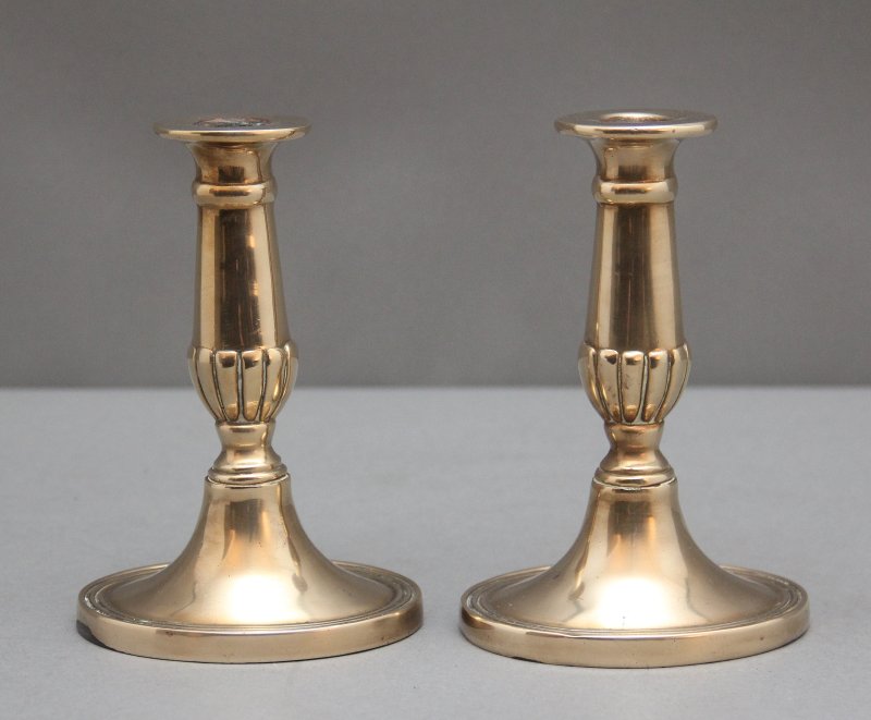 A pair of brass Georgian candlesticks