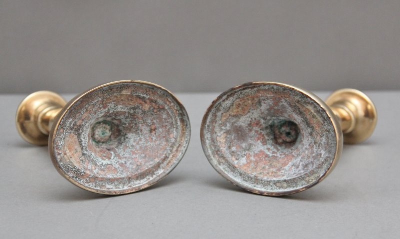 A pair of brass Georgian candlesticks