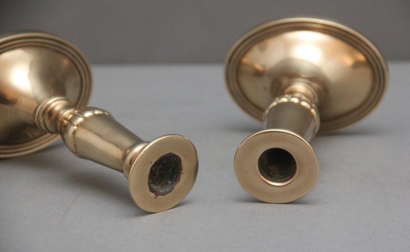 A pair of brass Georgian candlesticks