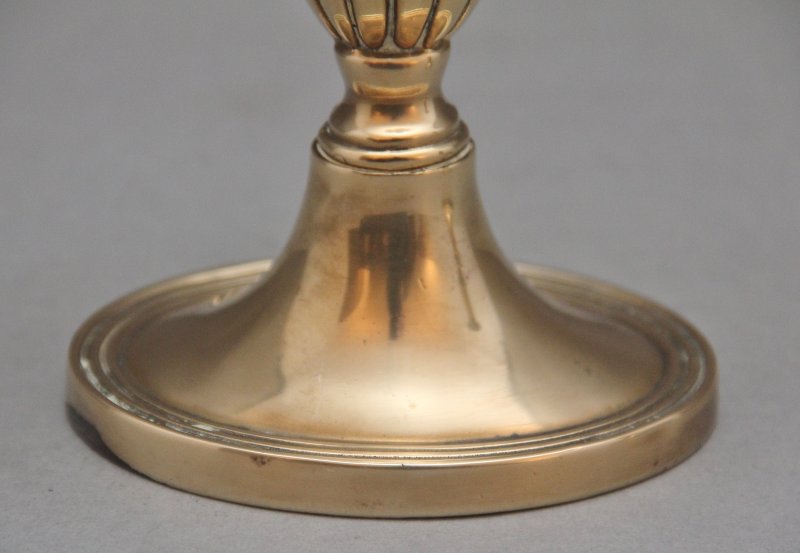 A pair of brass Georgian candlesticks