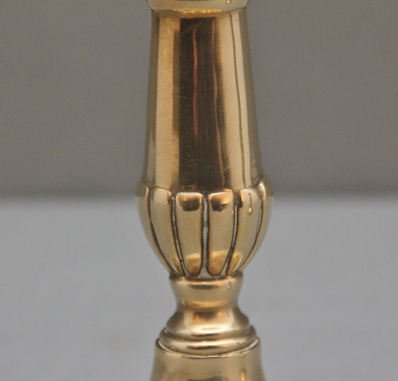 A pair of brass Georgian candlesticks