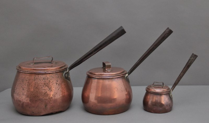 A set of three Victorian copper saucepans