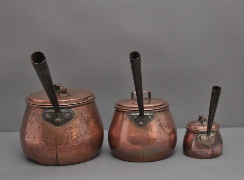 A set of three Victorian copper saucepans