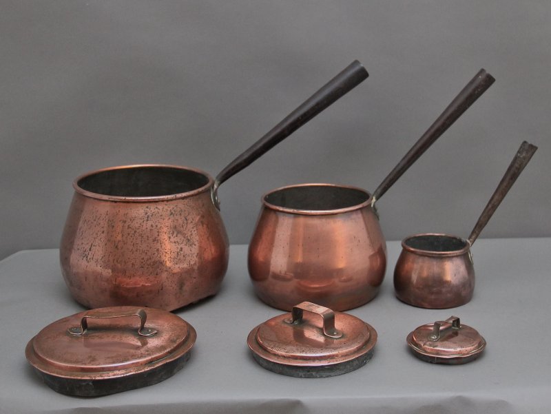 A set of three Victorian copper saucepans