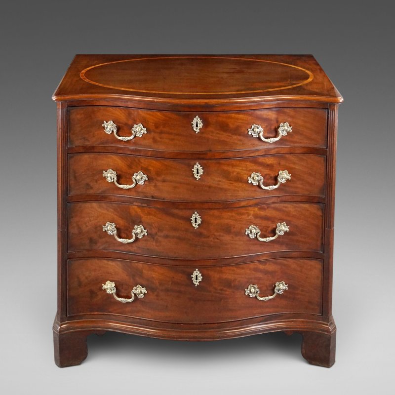 A George III Serpentine Chest Of Drawers