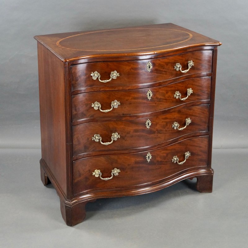 A George III Serpentine Chest Of Drawers