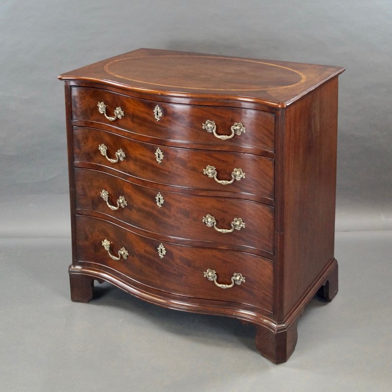 A George III Serpentine Chest Of Drawers
