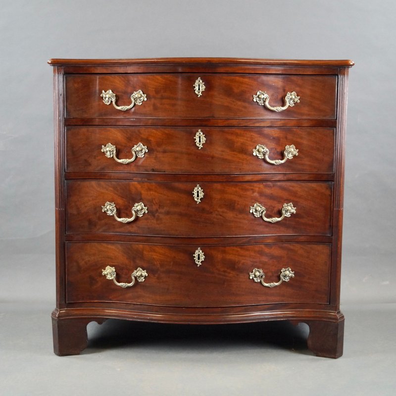 A George III Serpentine Chest Of Drawers