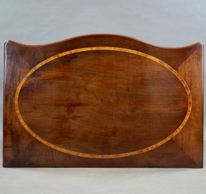 A George III Serpentine Chest Of Drawers