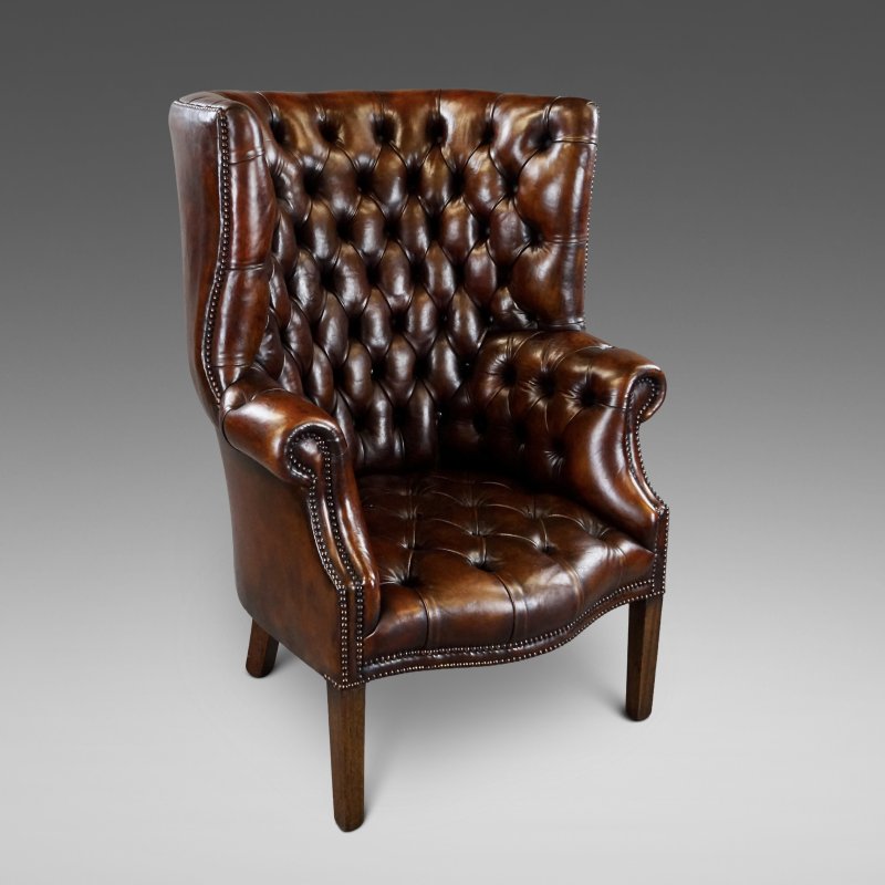A Deep Buttoned Chestnut Brown Barrel Back Wing Chair