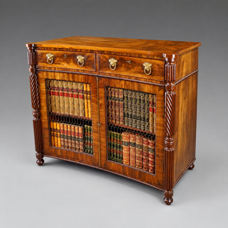 An unusual William IV mahogany concave side cabinet